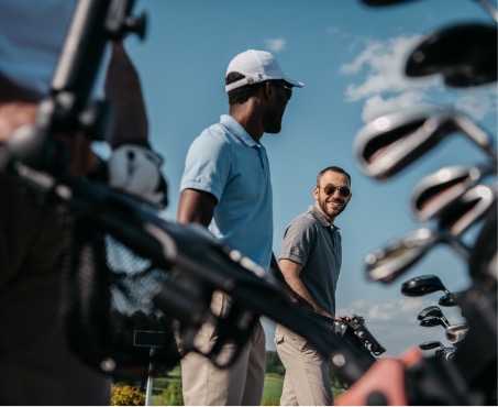 Two golfers sharing a moment between shots beside their golf bags