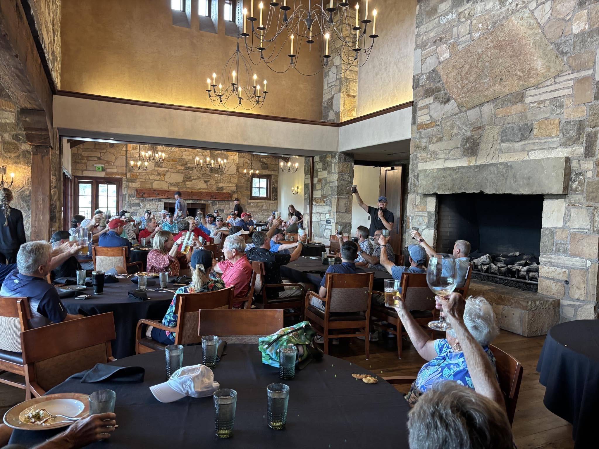 Tournament guests celebrating together at the clubhouse luncheon