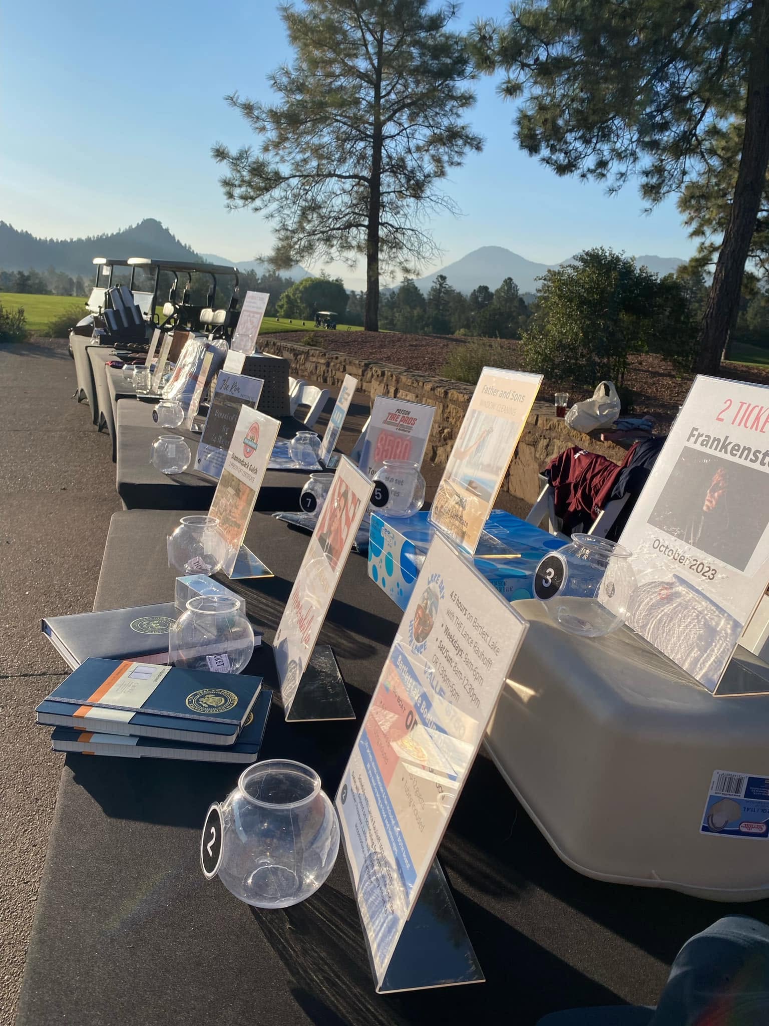 Tournament raffle prizes displayed beside the mountain golf course