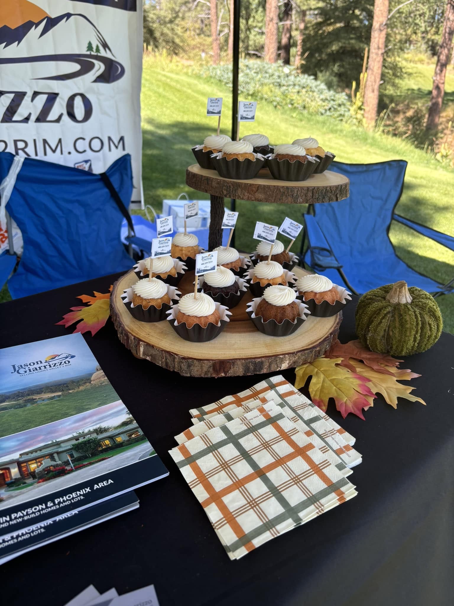 Cupcakes and sponsor materials displayed at a tournament hospitality table